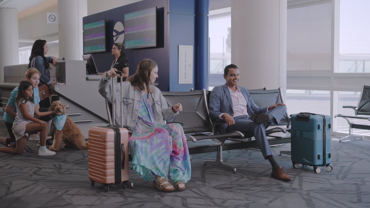 Travelers sharing an easy moment in an Ontario International Airport departure lounge